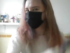 Girl painting her hair in surgical mask and gloves